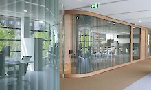 Meeting rooms and play room are behind the curved glass. Curtain from Kvadrat for privacy and acoustic